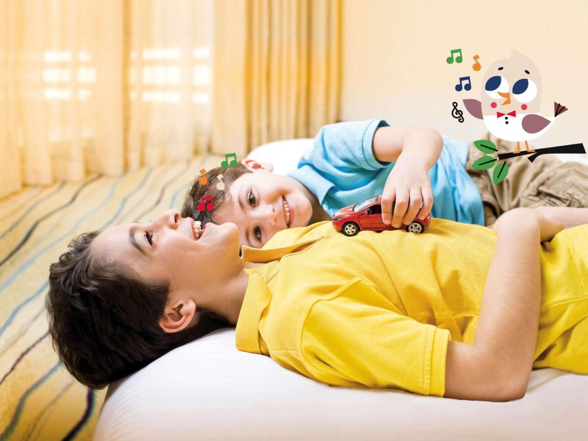דובאי Movenpick Jumeirah Village Triangle מראה חיצוני תמונה A child with autism playing with a toy car